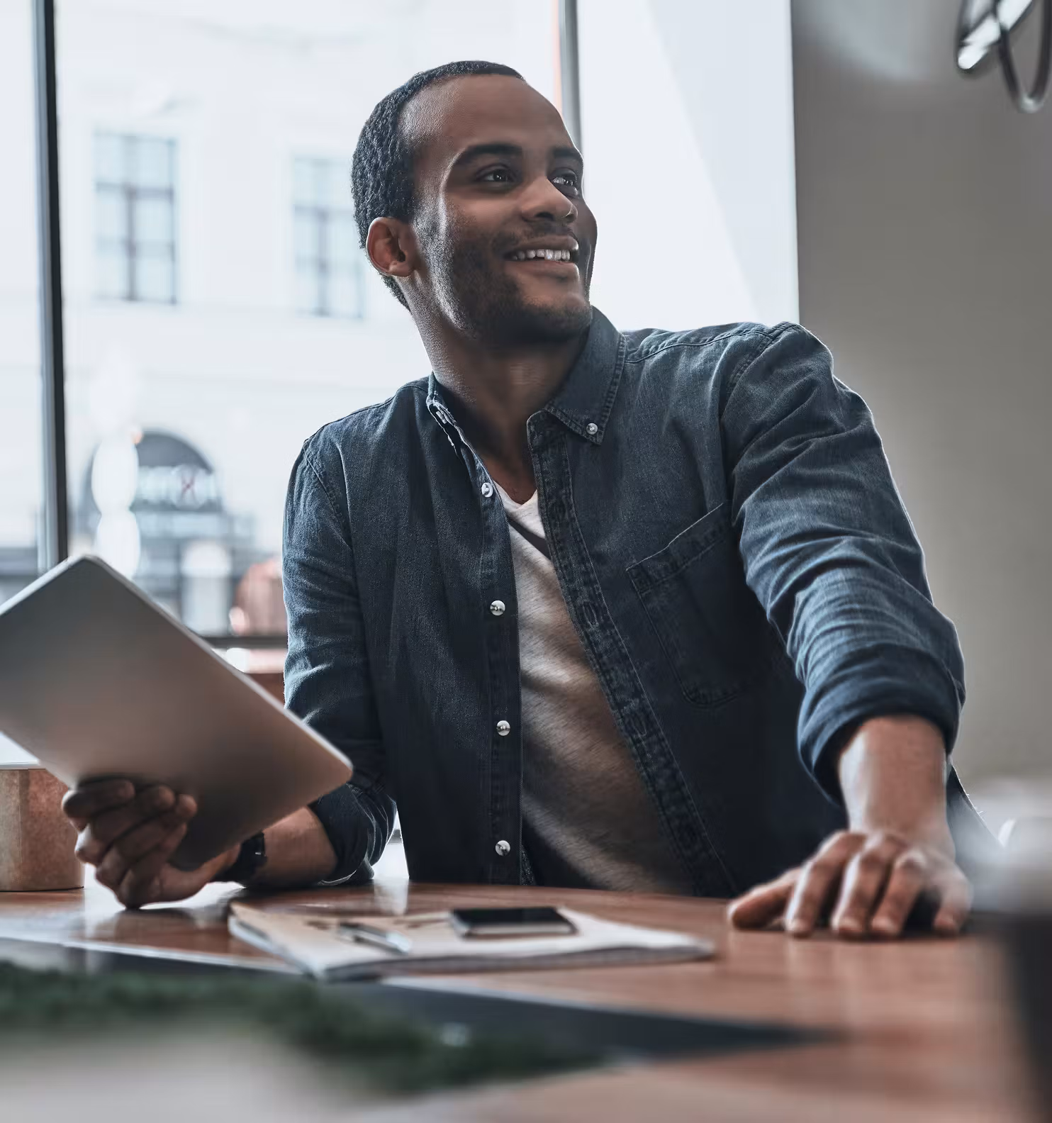 Person with iPad in hand smiling because PopCandi AI saved them time in recruiting
